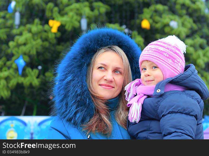 Happi Mom and girl near a Christmas tree