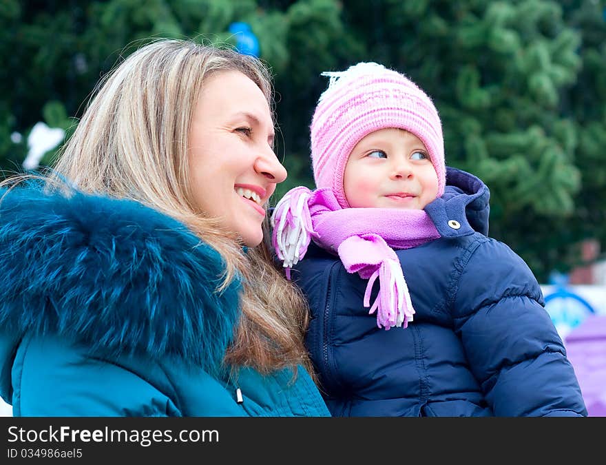 Mom and girl near a Christmas tree