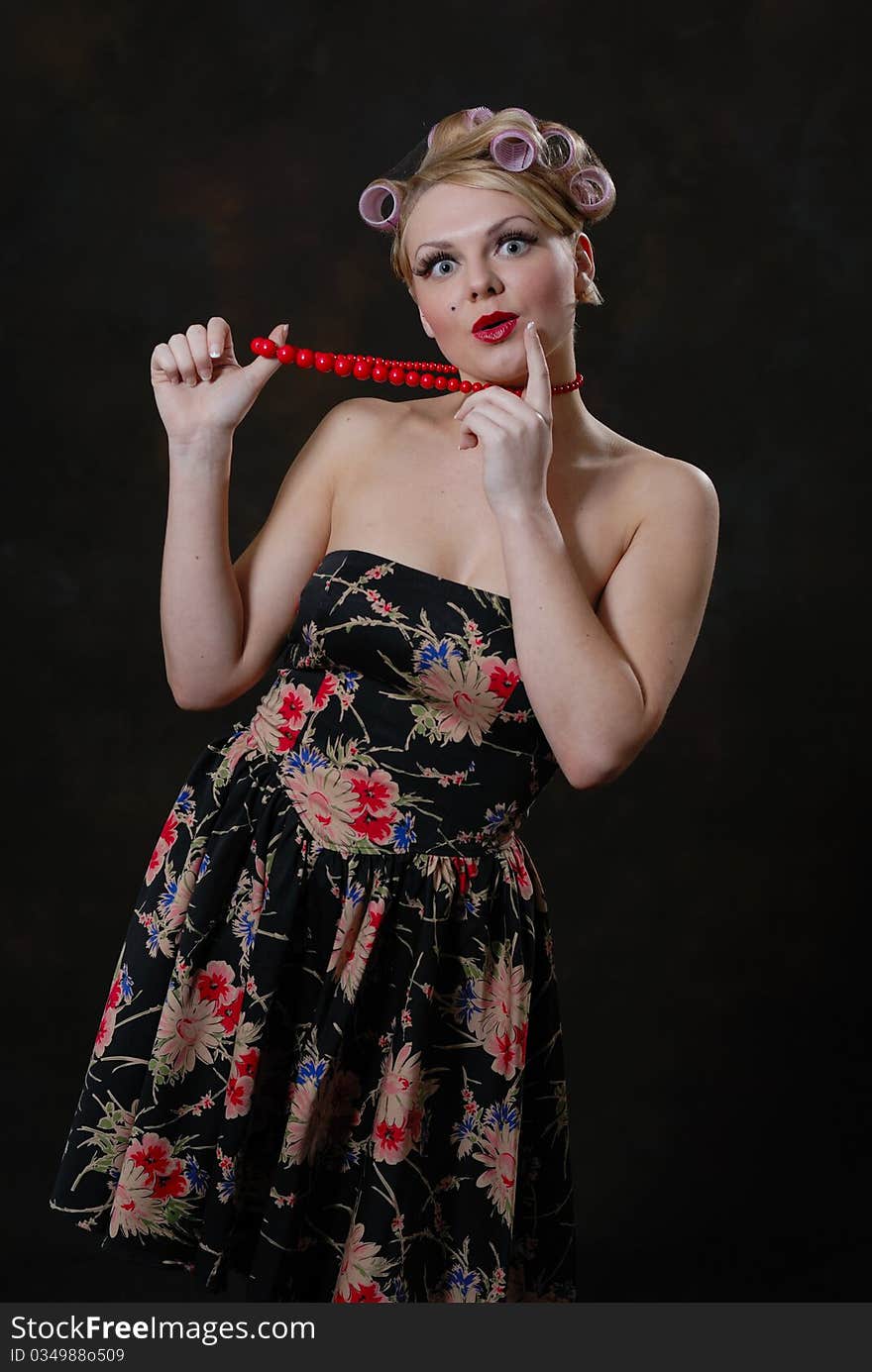 Photograph showing retro style 50s female posing against black. Photograph showing retro style 50s female posing against black