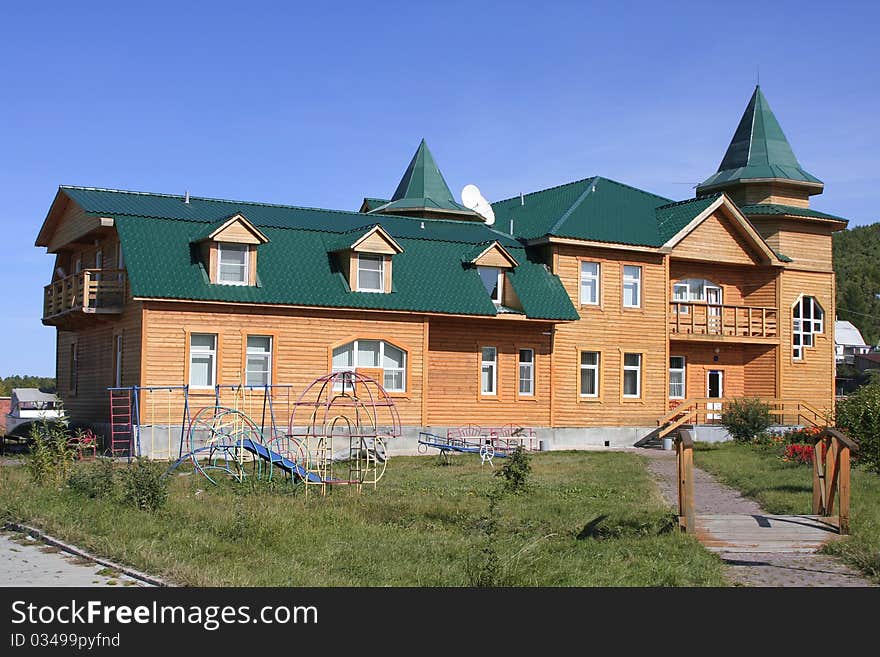 Wooden house in village on background blue sky