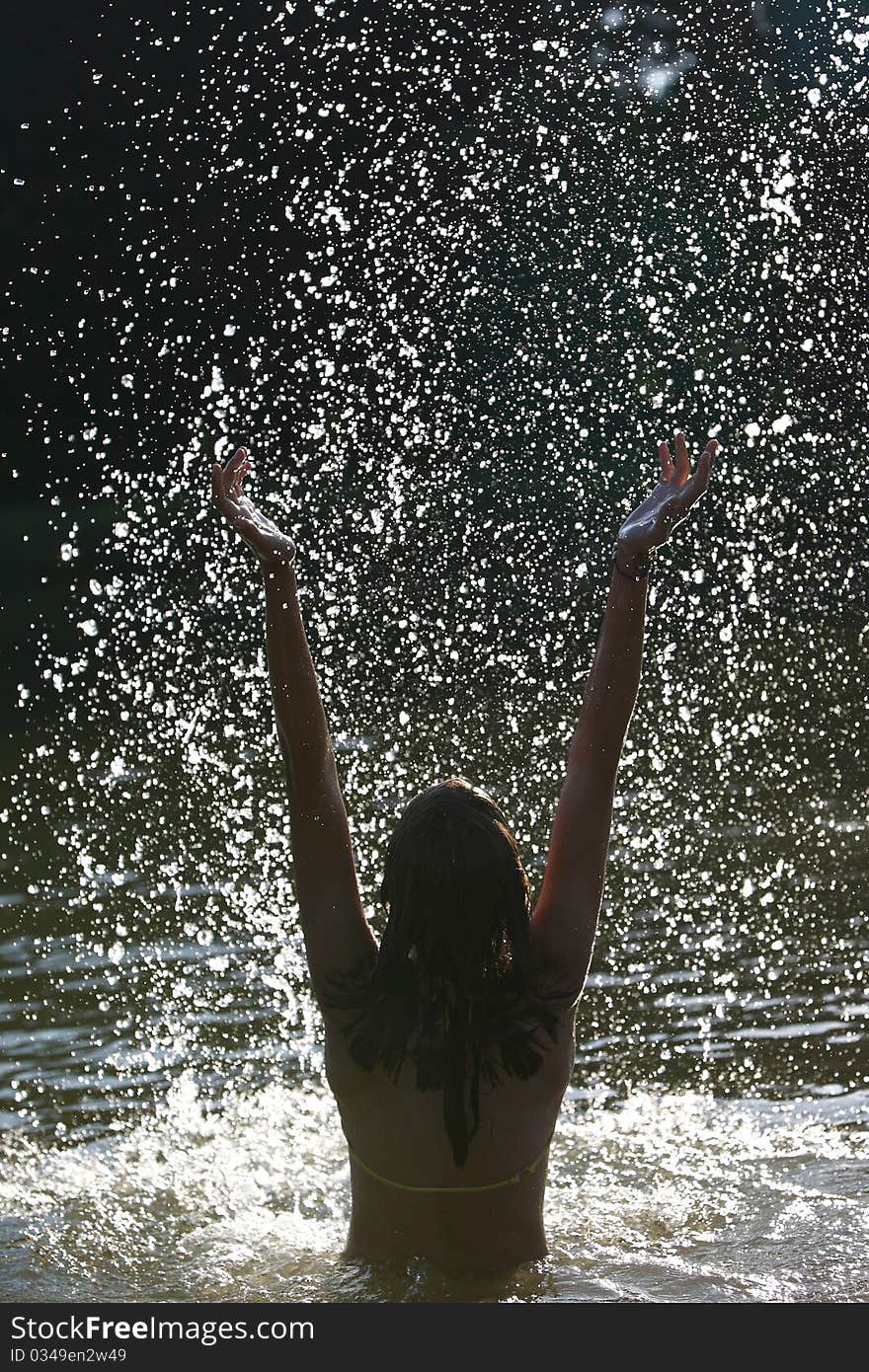 Young woman enjoying a bath in a lake