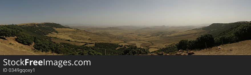 Panoramic view of Paysage D'Ito, a volcanic plateau littered with dark pumice rock in Middle Atlas, near Azrou, Morocco. Panoramic view of Paysage D'Ito, a volcanic plateau littered with dark pumice rock in Middle Atlas, near Azrou, Morocco