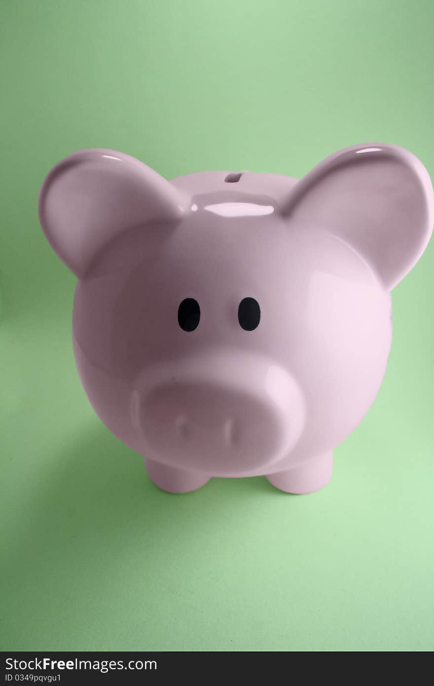 Pink piggy bank with green background.