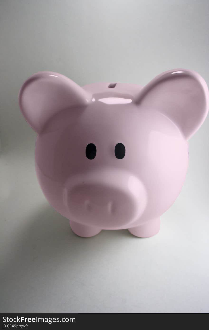 Pink piggy bank with white background.