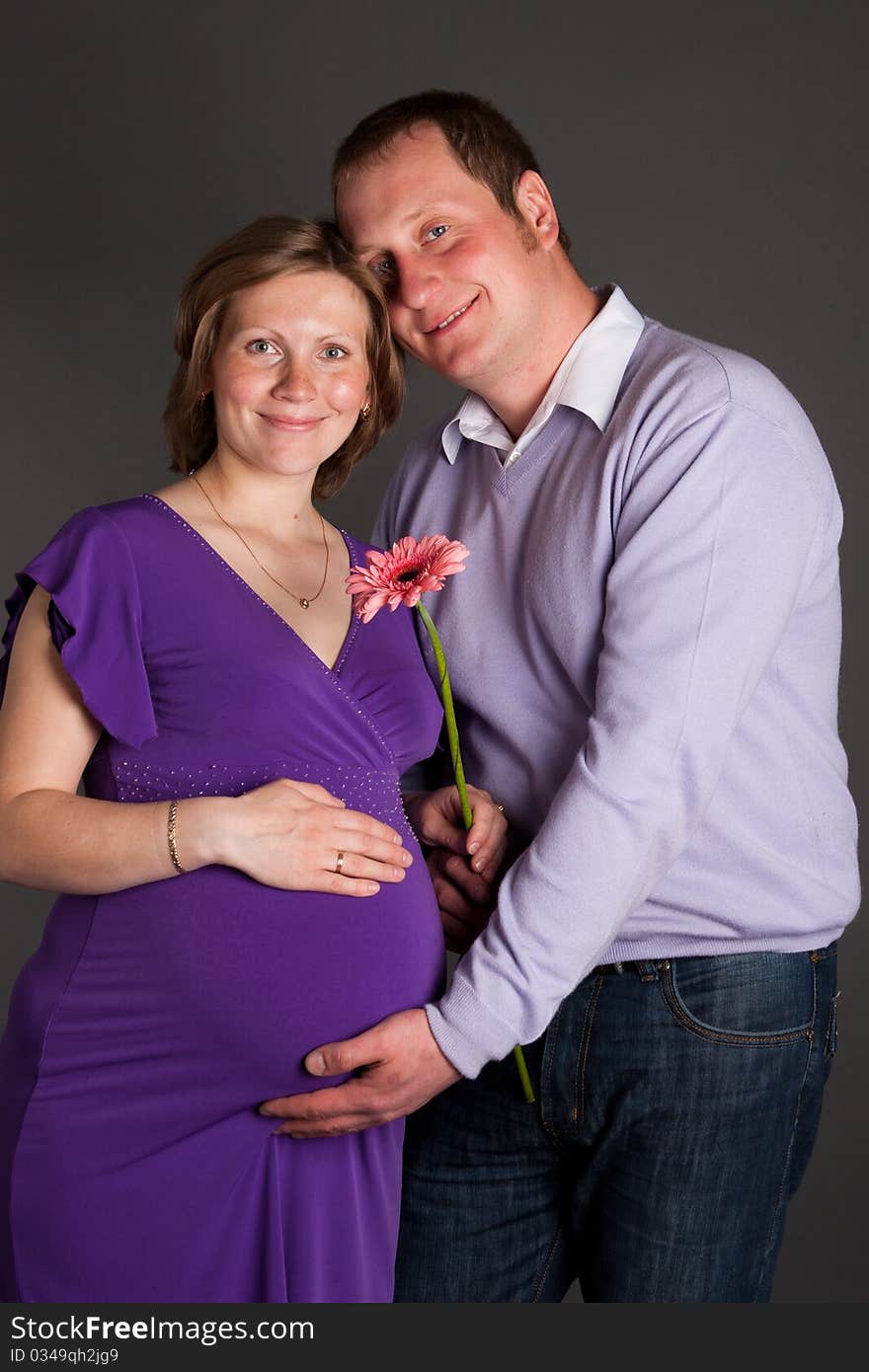 Pregnant woman with flower and her husband. Pregnant woman with flower and her husband