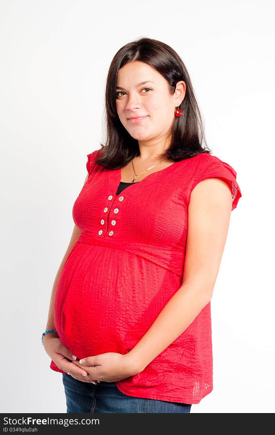 Beautiful pregnant woman staing on light grey background