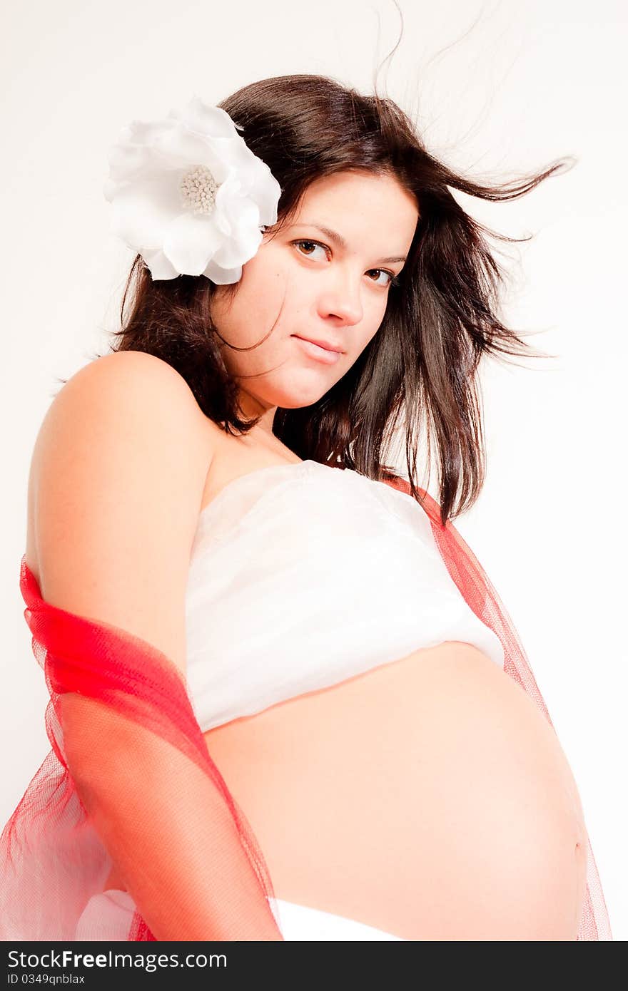 Beautiful pregnant woman staing on light grey background, close up