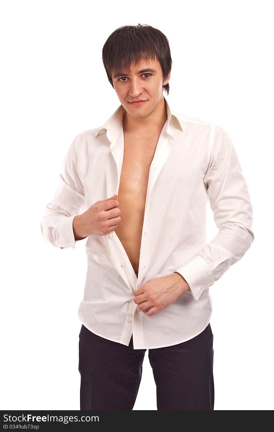 The young guy undresses on a white background. The young guy undresses on a white background