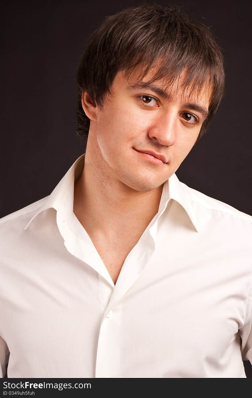 Portrait adult guy on black backdrop