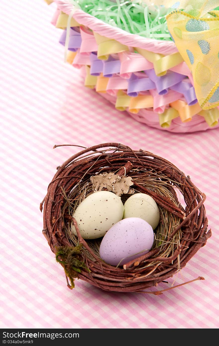 Easter Painted Colorful eggs in birds nest for sunday morning on a pastel color background. Easter Painted Colorful eggs in birds nest for sunday morning on a pastel color background