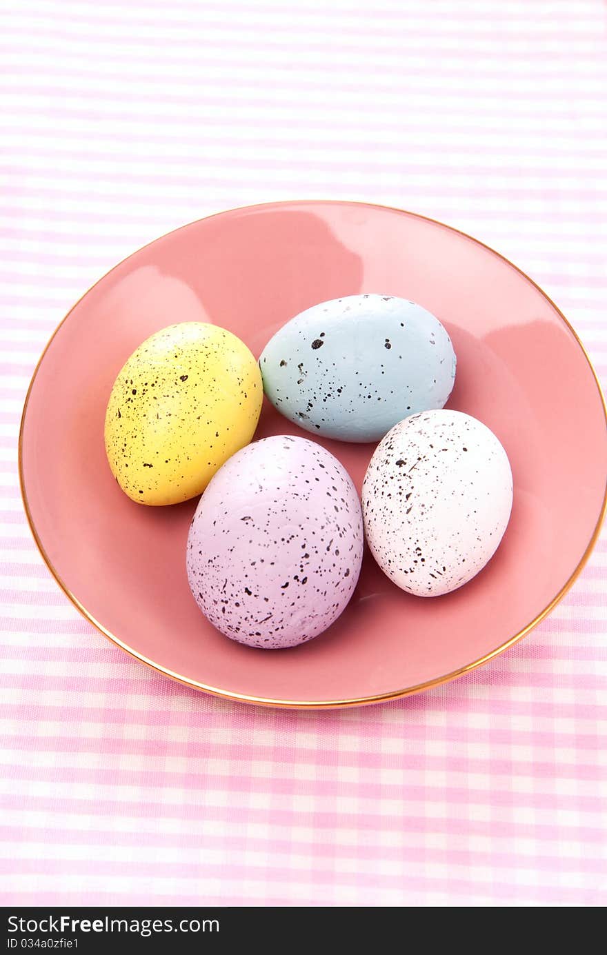 Easter Painted Colorful eggs on a saucer for sunday morning on a pastel color background