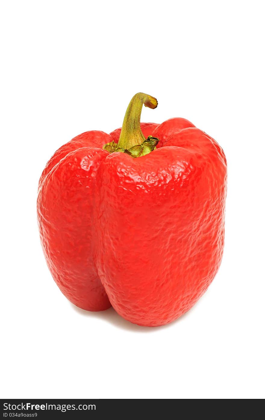 Red wrinkled pepper on a white isolated backround