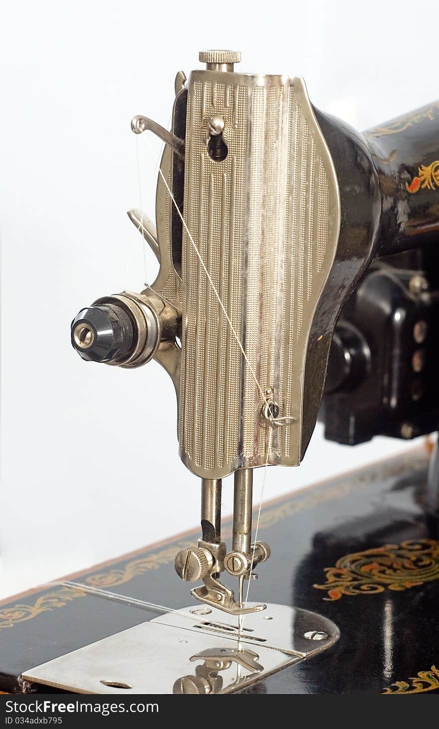 Hand sewing machine one black on the old wooden stand. Hand sewing machine one black on the old wooden stand.