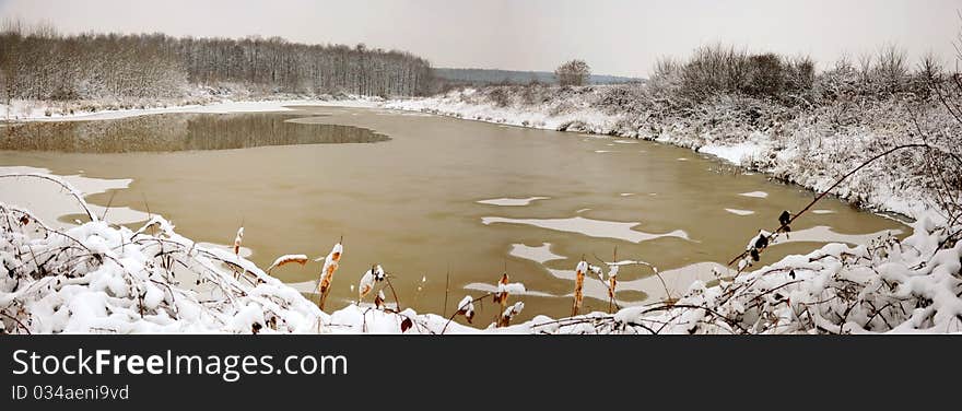 Iced lake near winter forest