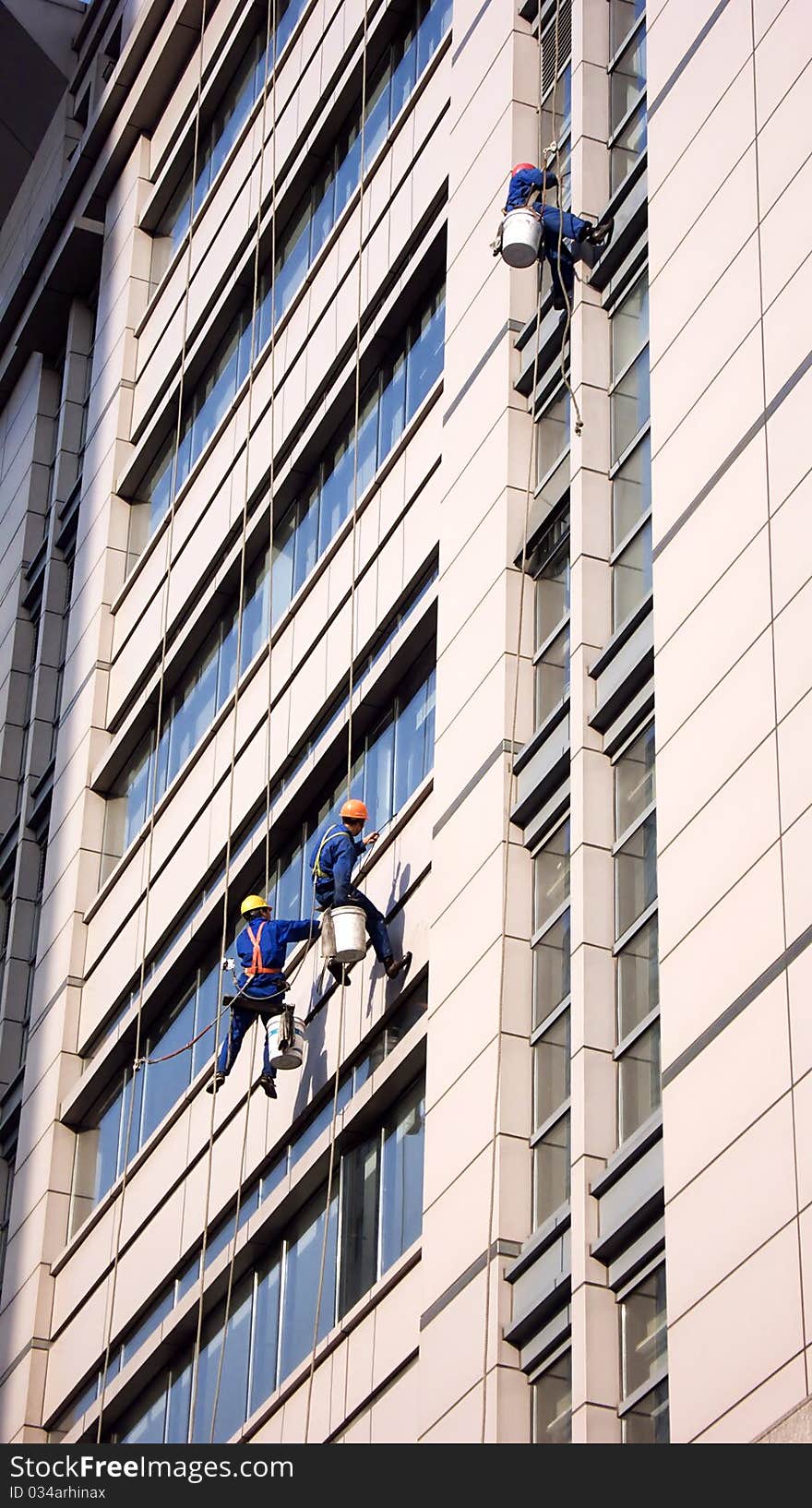 Building Cleaning Workers Cleaning Skyscraper Windows in Shanghai. Building Cleaning Workers Cleaning Skyscraper Windows in Shanghai.