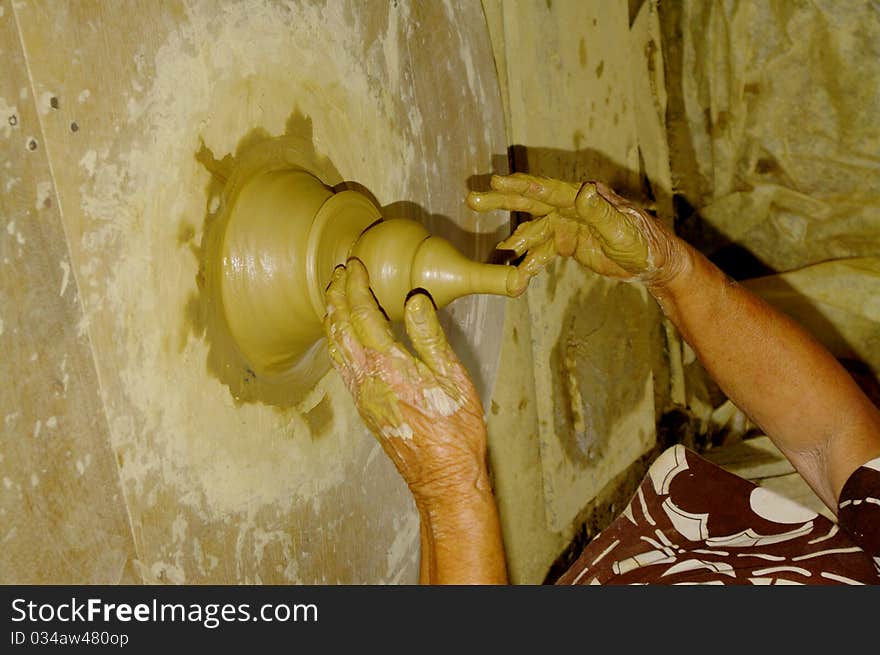 The Hands Of The Potter Making A Vase In Argil .