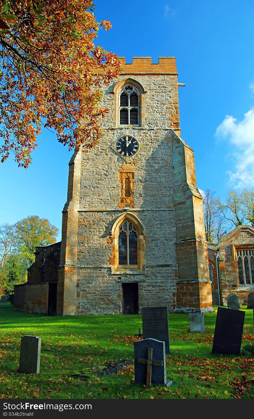 Yelvertoft Church Clock Tower through Autumn Leaves, Yelvertoft, Northamptonshire, England.  The Church at Yelvertoft was one that was ransacked by Oliver Cromwell's army, but survived as a good example of the use of Northamptonsire Stone. Yelvertoft Church Clock Tower through Autumn Leaves, Yelvertoft, Northamptonshire, England.  The Church at Yelvertoft was one that was ransacked by Oliver Cromwell's army, but survived as a good example of the use of Northamptonsire Stone.