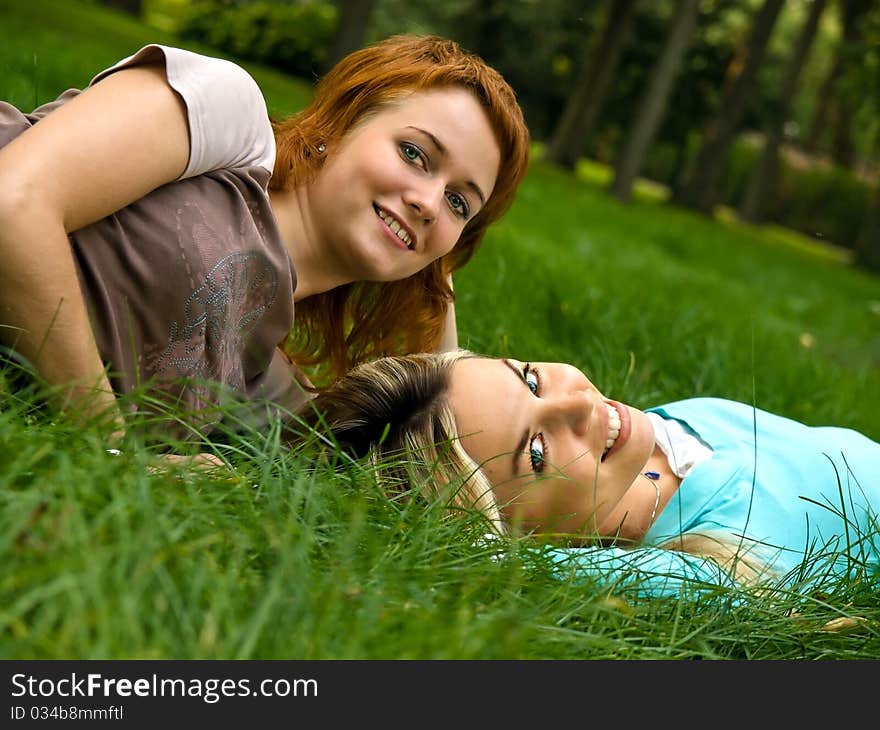 Two girls resting on the grass