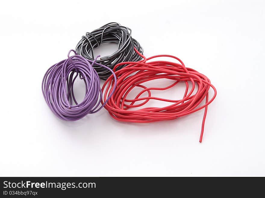 Close up of electric wire on a plain white background.