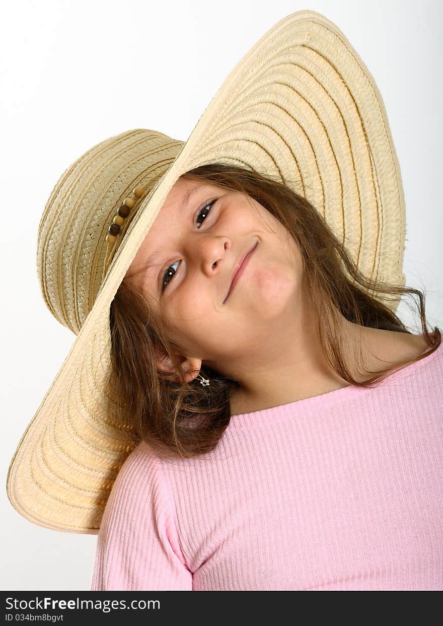 Portrait of little girl with brown eyes wearing straw hat on white. Portrait of little girl with brown eyes wearing straw hat on white