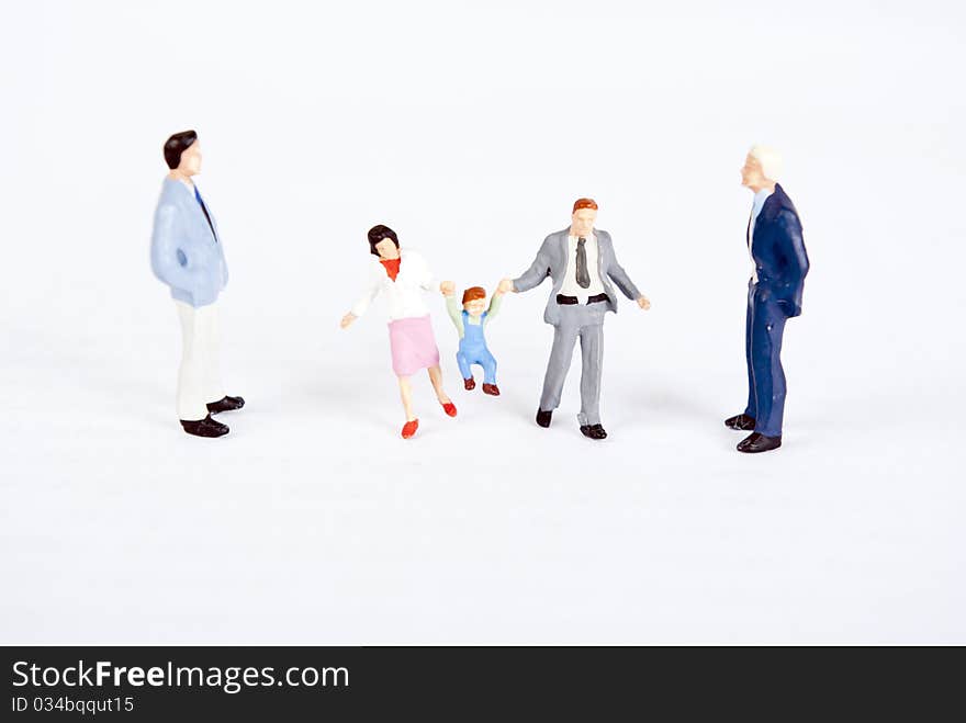 Miniature people with family on white