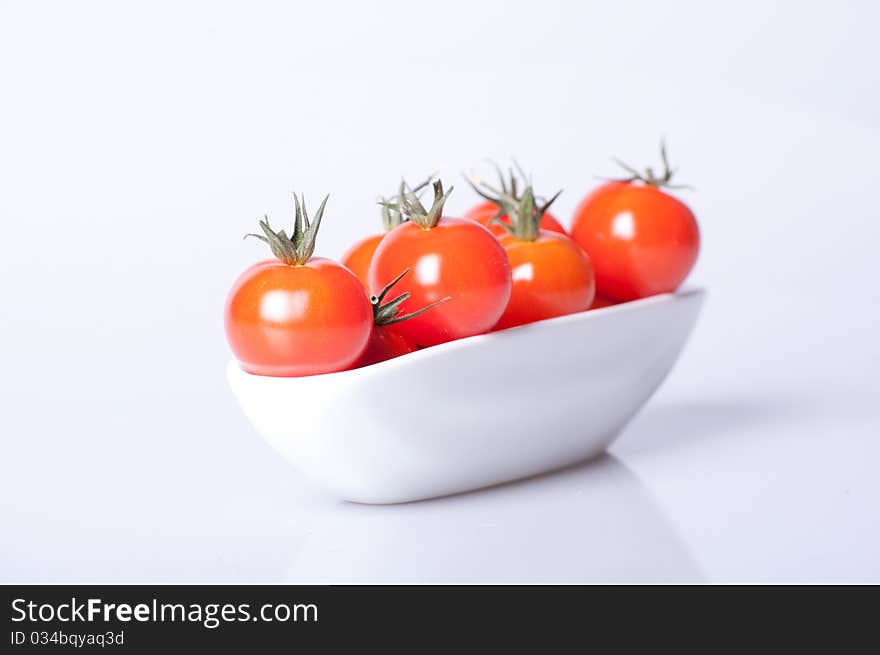 Fresh tomato in white dish with clean lighting. Fresh tomato in white dish with clean lighting