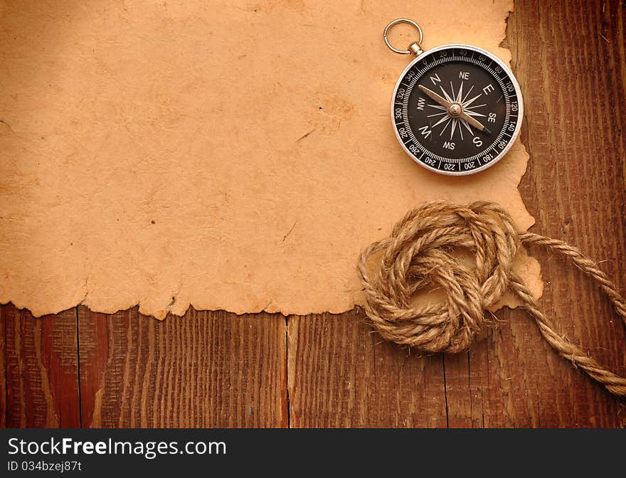 Compass and rope on grunge paper background. Compass and rope on grunge paper background