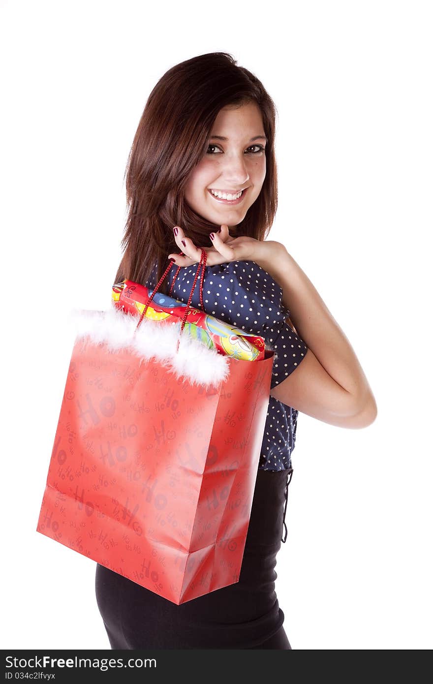 A young woman is smiling while looking over her shoulder holding a bag. A young woman is smiling while looking over her shoulder holding a bag.