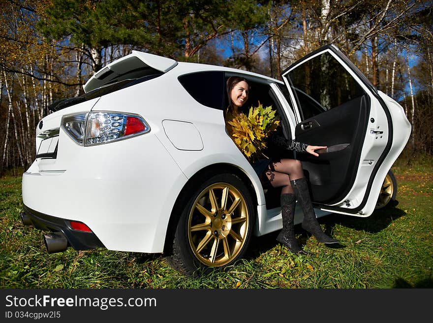 Happy Girl With Yellow Leaves In White Stylish Car