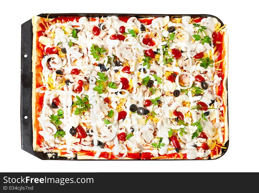 Pizza in baking tray waiting for oven. Isolated on white.