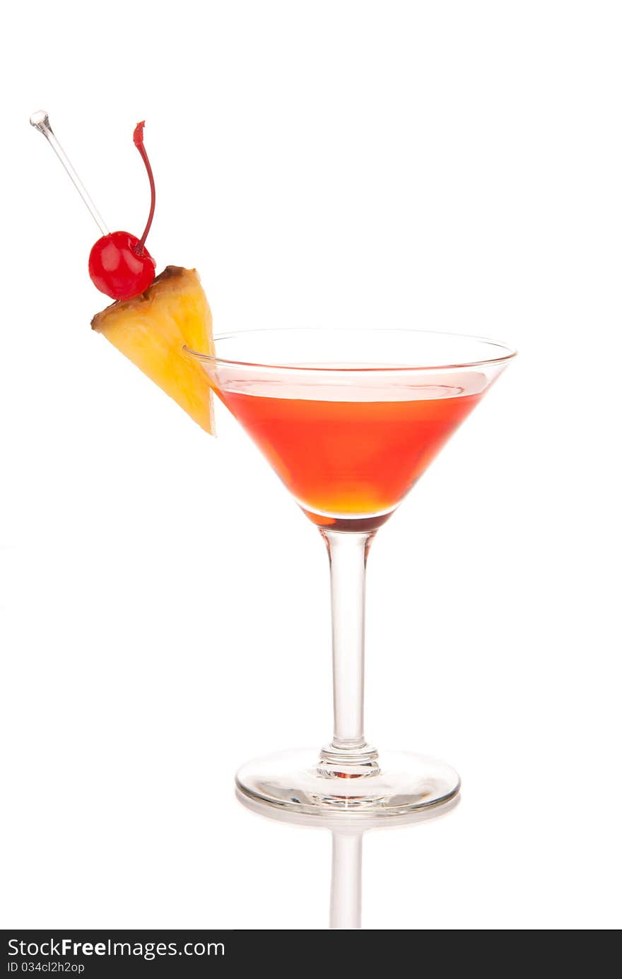 Red Cosmopolitan cocktail with vodka, rum, triple sec, red cranberry and lemon juice, pineapple, maraschino cherry in martini glass isolated on a white background. Red Cosmopolitan cocktail with vodka, rum, triple sec, red cranberry and lemon juice, pineapple, maraschino cherry in martini glass isolated on a white background