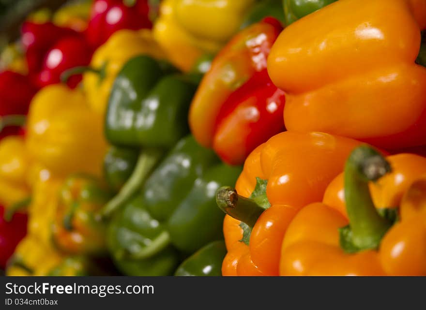 Red peppers, yellow peppers, and green peppers at a local market. Red peppers, yellow peppers, and green peppers at a local market