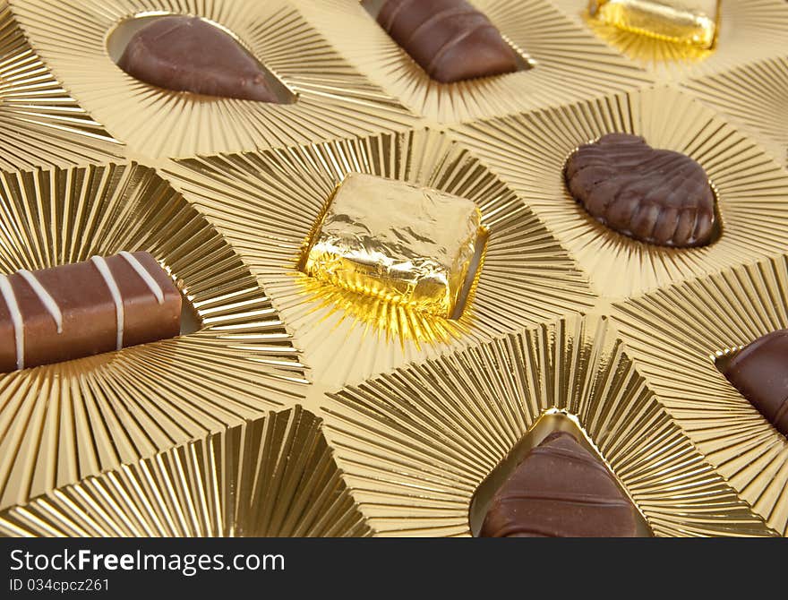 Box of chocolates with gold background