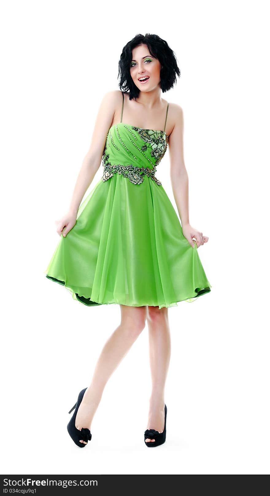 Beautiful young girl posing in a green dress