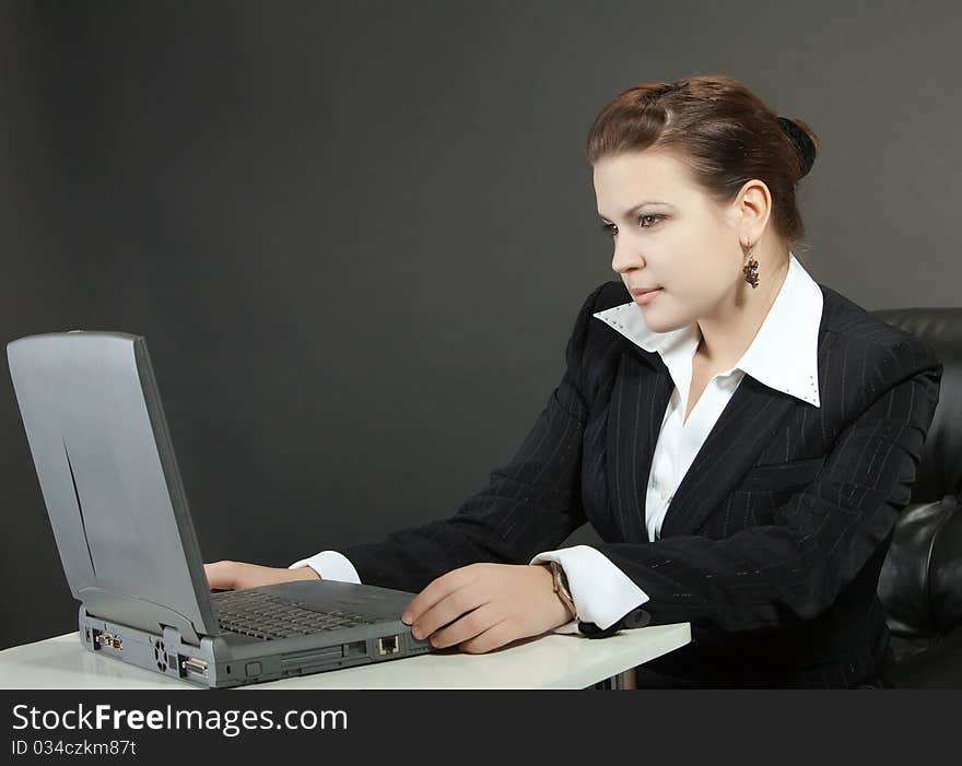 Young woman works on a computer in a office. Young woman works on a computer in a office