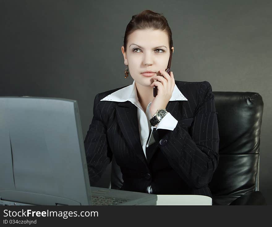 Young woman works on a computer in a office. Young woman works on a computer in a office