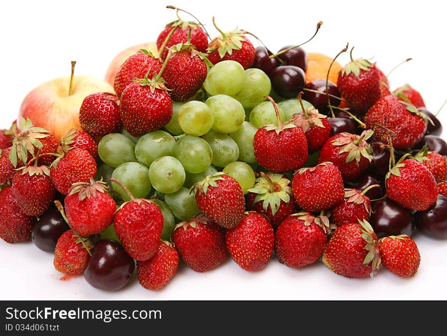 Fresh fruit and berries on a white background