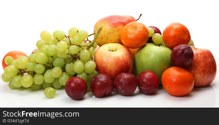 Fresh fruit and berries on a white background