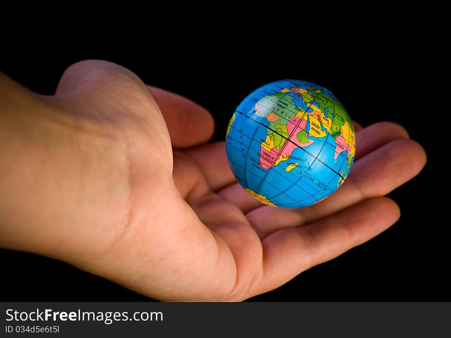 Close up of globe hanging above the palm