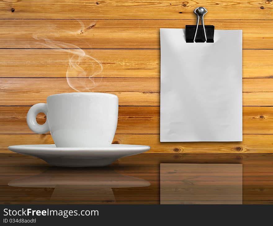 A White Cup Of Coffe And White Paper