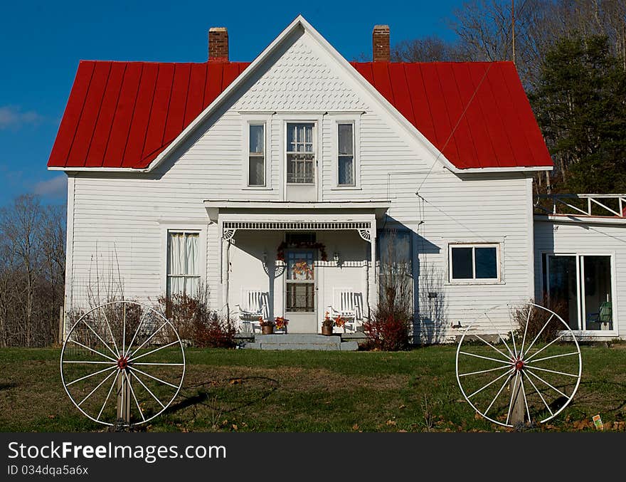 Rural white house with a red roof