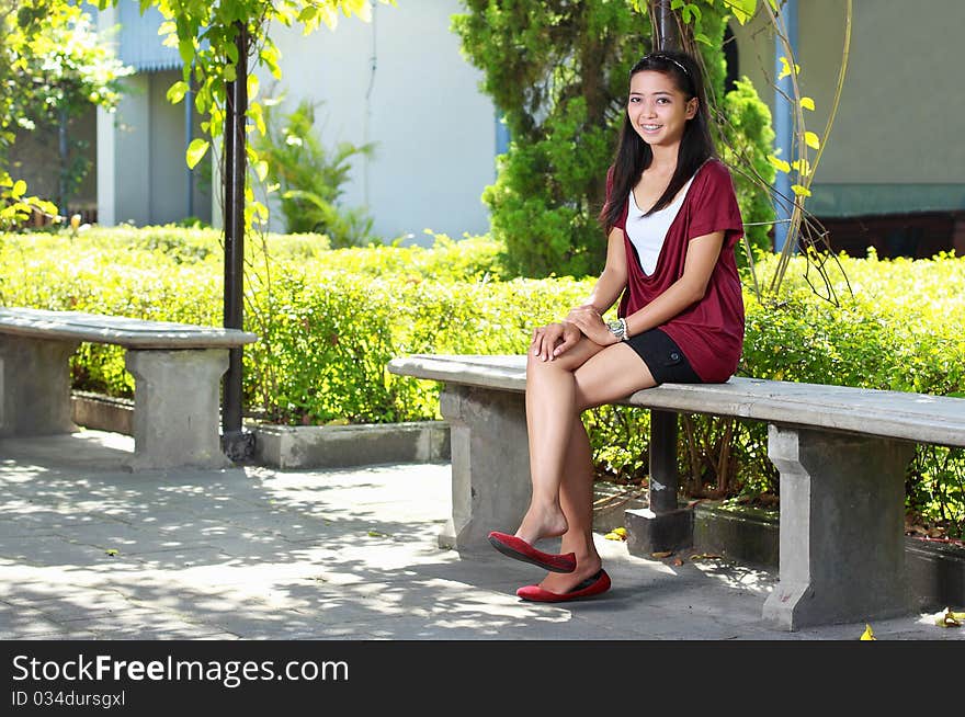 Young beautiful girl in the park smiling. Young beautiful girl in the park smiling