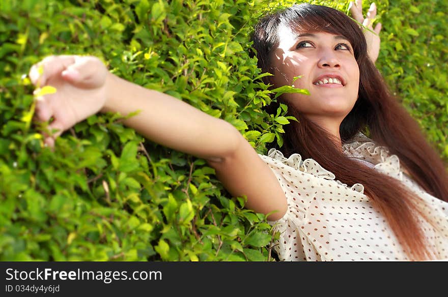 Young beautiful girl lying down in the park smiling. Young beautiful girl lying down in the park smiling