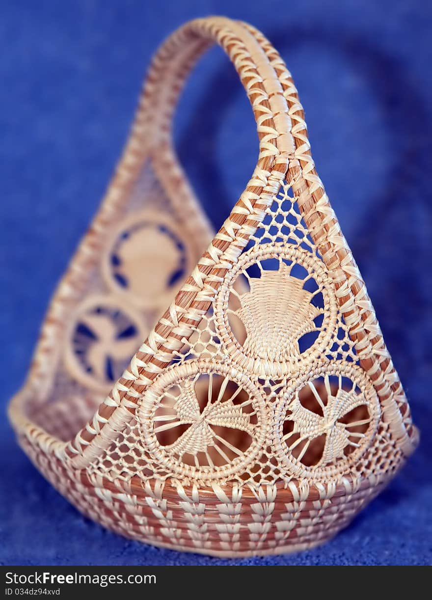 A natural handwoven ethnic basket with intricate designs. A natural handwoven ethnic basket with intricate designs.