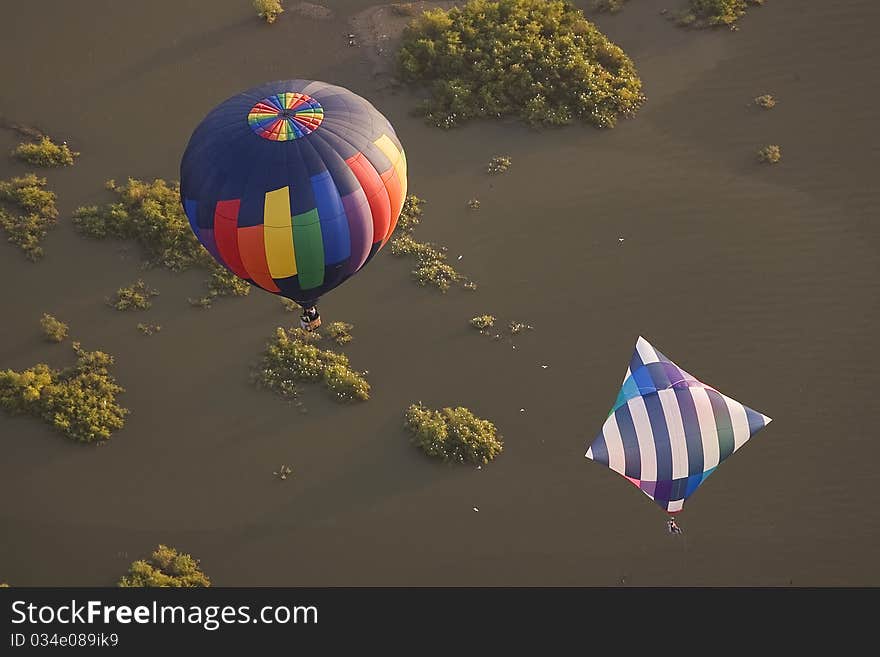 Two hot air balloons over water