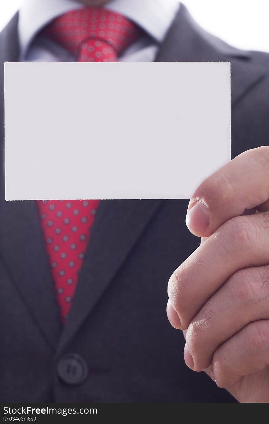 Businessman in grey suit and a blue shirt with a red power tie, shows businesscard with copy space, shallow dept of field. Businessman in grey suit and a blue shirt with a red power tie, shows businesscard with copy space, shallow dept of field