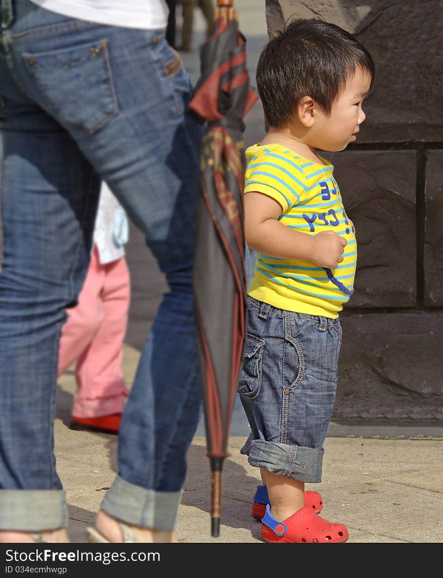 A cute baby is playing in a garden. A cute baby is playing in a garden