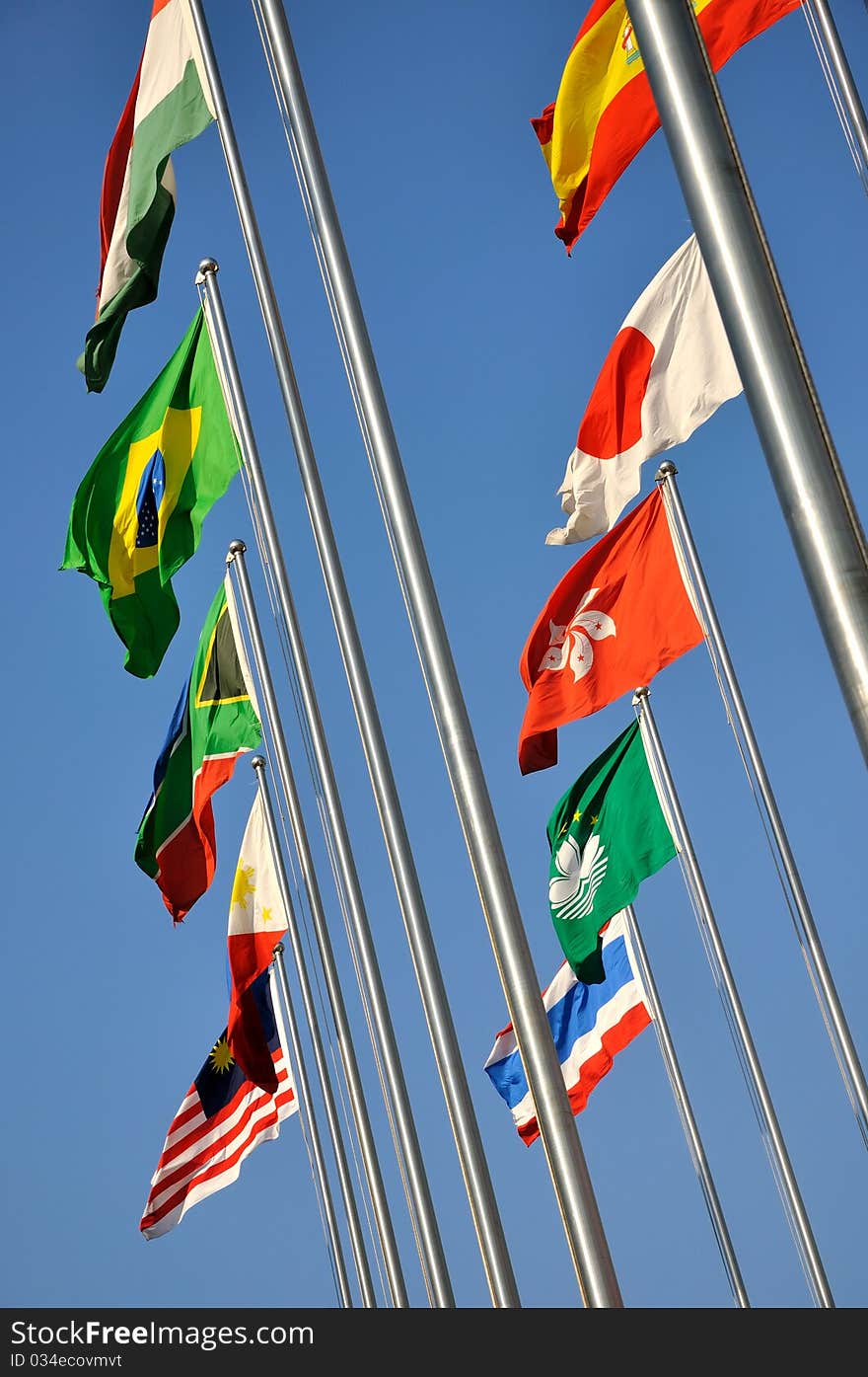 Different countries national flags on pole together, shown as worldwide, country, and international communication or activities. Different countries national flags on pole together, shown as worldwide, country, and international communication or activities.