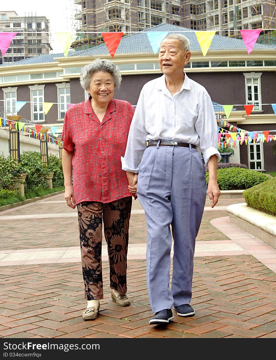 An intimate senior couple are walking. An intimate senior couple are walking