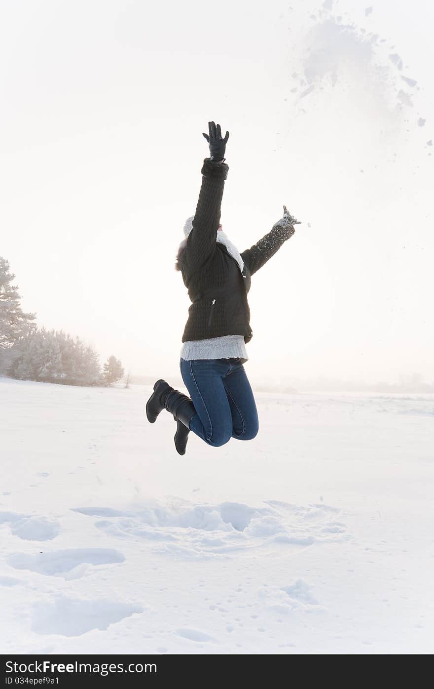 Girl jumping at snow